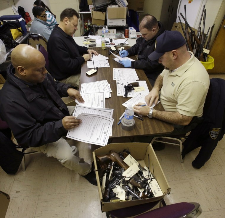 Officers from the Mercer County Prosecutor's Office work at a two-day gun buyback event in Trenton, N.J., on Jan. 26. People were allowed to drop off weapons with no questions asked.
