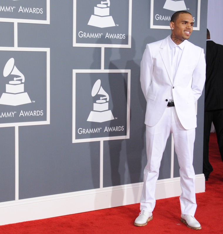 Resplendent in white: Chris Brown arrives at the 55th annual Grammy Awards on Sunday.