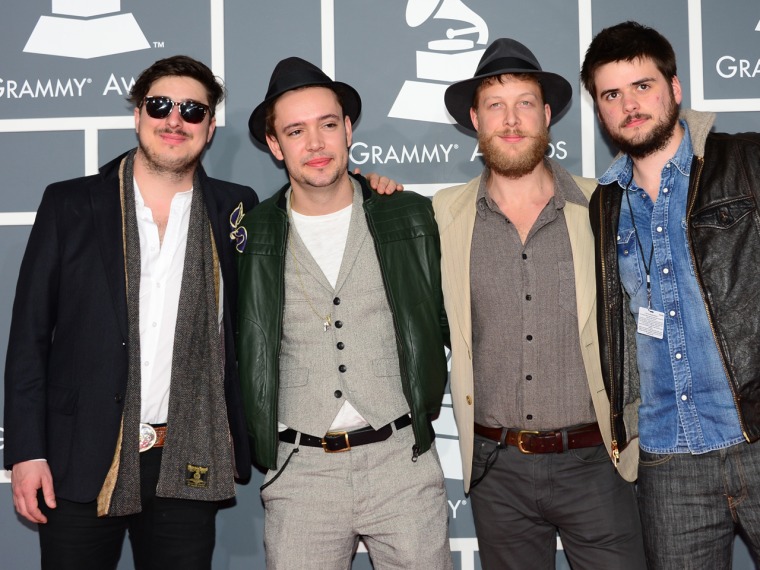 Nominees for Album of the Year, Best Rock Performance, Best Rock Song and Best Americana Album Mumford & Sons arrive on the red carpet with hats on heads.