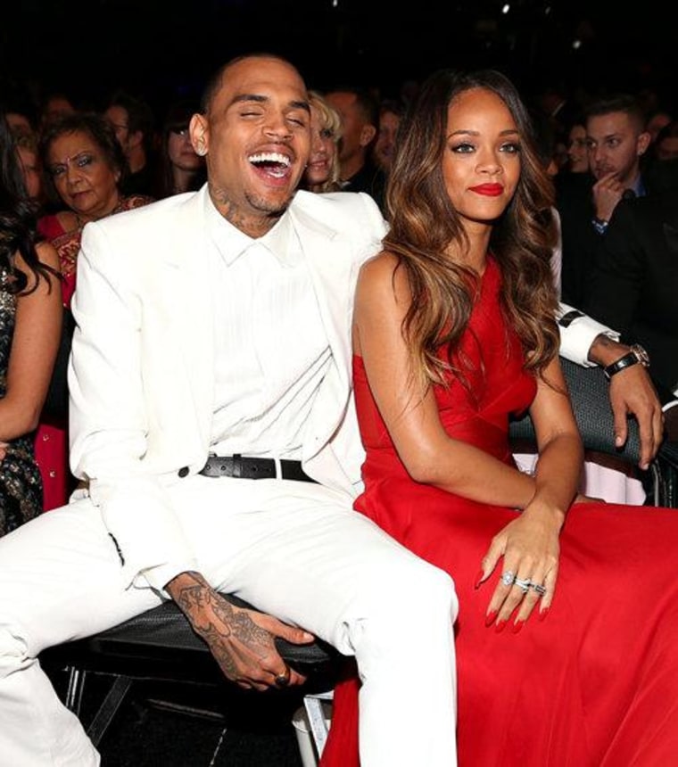 Are-they-aren't-they couple Chris Brown and Rihanna cozied up to each other in the crowd.