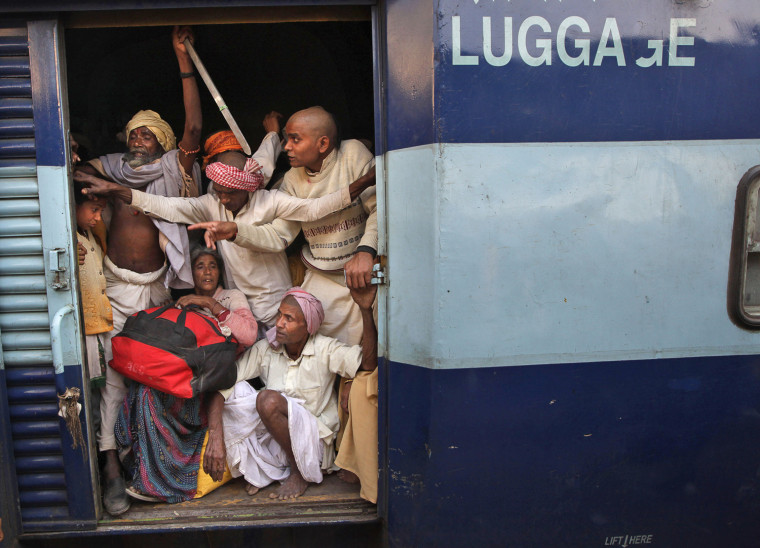 Hindu devotee returning from Maha Kumbh festival travel in an luggage van of a train from the main railway station of Allahabad on Feb. 13.