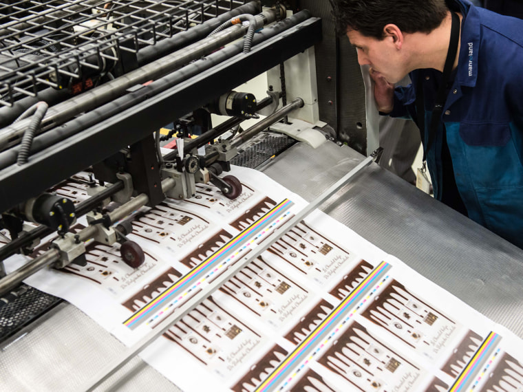 A worker looks at sheets of chocolate stamps at the Bpost (belgian post) postage stamp press in Mechelen, Belgium.