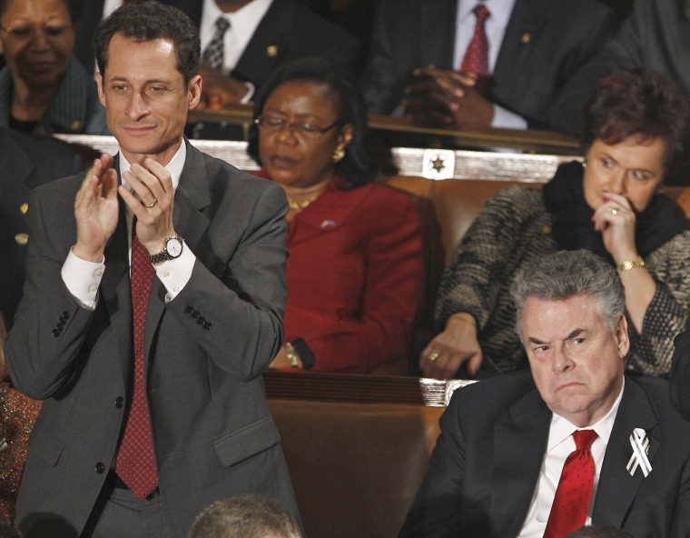 Rep. Anthony Weiner, D-N.Y., left, applauds during President Barack Obama's State of the Union address in 2011 as an unidentified woman appears to sleep behind him. Rep. Peter King is at right.