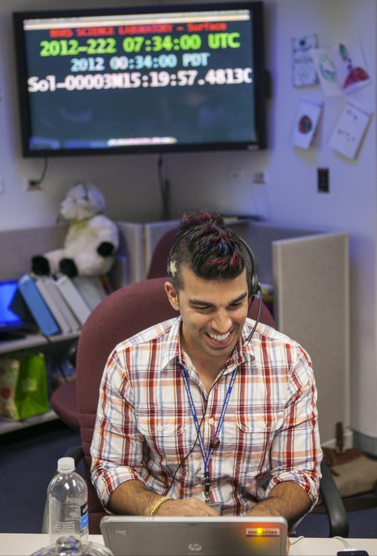 Bobak Ferdowsi, a flight director for the Mars rover Curiosity, works at his computer at the Surface Mission Support Area, at NASA's JPL in Pasadena, Calif. Known to the Twitterverse and the president of the United States as