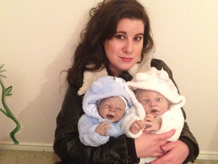 Comfortable with the creepy: Lexi Friberg with two of her 20 \"monster baby\" dolls.