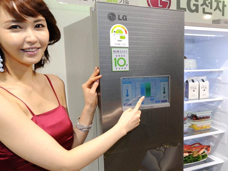 A South Korean model poses with an LG Electronics refrigerator connected to a home Wi-Fi network that can be controlled by a smartphone, during a launching event in Seoul on April 19, 2011. New smart fridges like this one and another from Samsung are due out soon.