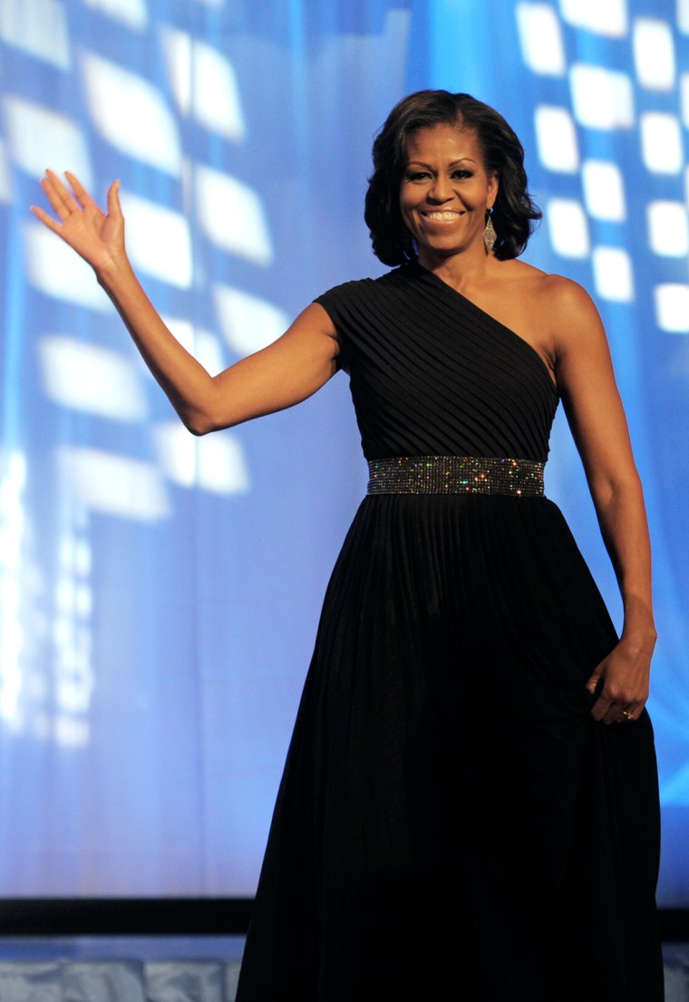 Michelle Obama, wearing Michael Kors, waves as she walks onstage to address the Congressional Black Caucus Foundation's 42nd Annual Phoenix Awards dinner in Washington on Sept. 22.
