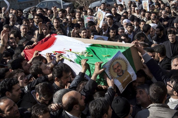 Iranian mourners carry the flag-draped coffin of Hessam Khoshnevis, identified in some reports as Gen. Hassan Shateri, in Tehran on Thursday. He was killed this week while traveling from Syria to Lebanon.