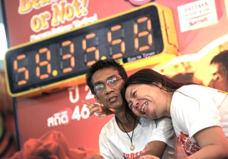 Thai couple Ekkachai and Laksana Tiranarat make a new world's record for longest continuous kiss at 58 hours, 35 minutes, and 58 seconds during an event n Pattaya, southeastern Thailand on Feb. 14.