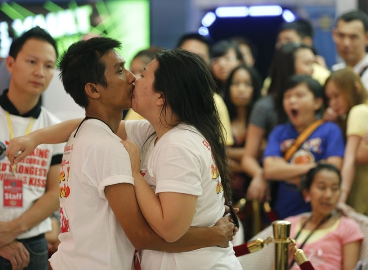 Ekkachai Tiranarat kisses his wife Laksana during an attempt to break the Guinness World Record time for longest continuous kiss in Thailand on Valentine's Day. The Laksanas were eventually successful by beating nine other married couples with a time of 58:35:58.