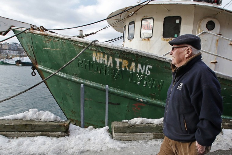 In this photo taken Wednesday, Feb. 13, 2013, Ron Gilson, a 79-year-old life Gloucester native, walks along the fish pier in Gloucester, Mass.