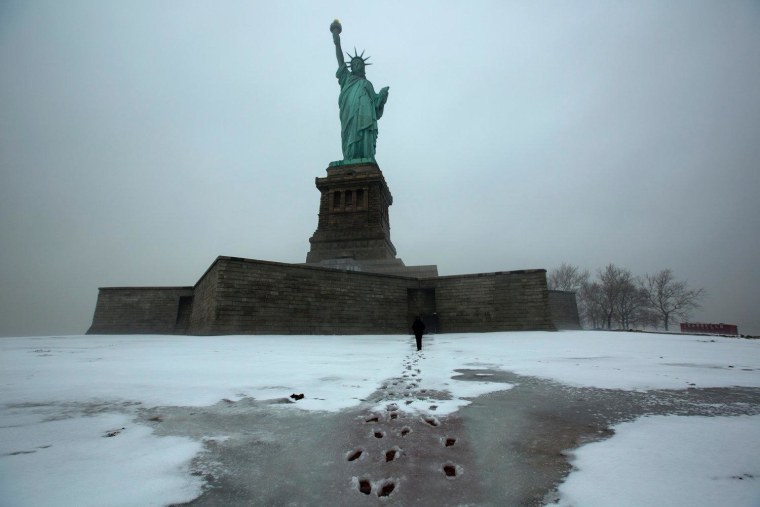 A police officer makes his rounds at the Statue of Liberty National Monument which has been been closed since Hurricane Sandy.