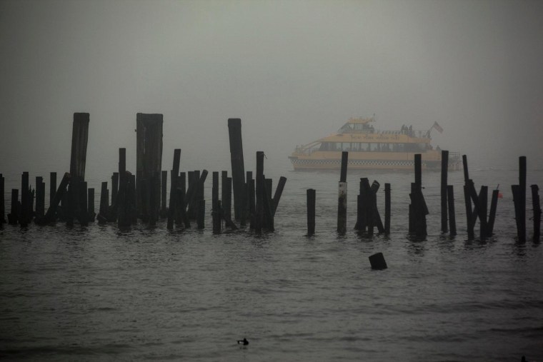 A tour boat passes the heavily damaged auxiliary dock on Liberty Island.