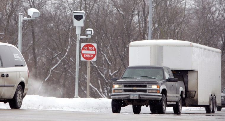 Traffic passes a red light camera at an intersection in Clive, Iowa.