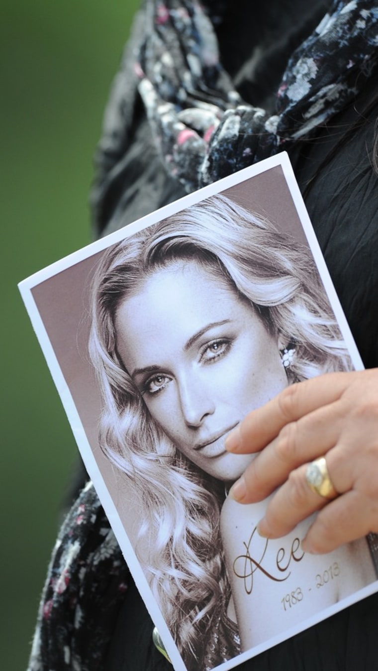 A mourner at model Reeva Steenkamp's funeral holds the ceremony program Tuesday.
