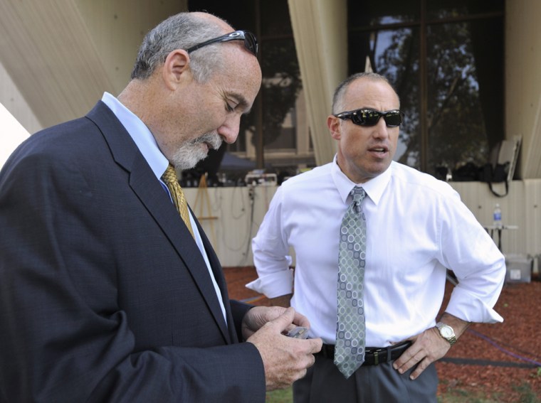 In this Sept. 6, 2012 file photo, Joel Brodsky, left, and Steven Greenberg, attorneys for former Bolingbrook, Ill., police officer Drew Peterson, confer outside the Will County Courthouse in Joliet, Ill., during the jury deliberations in Peterson's murder trial.