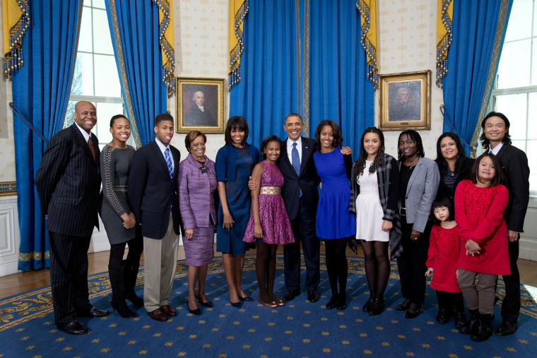 President Barack Obama, first lady Michelle Obama, and daughters Sasha and Malia, center, join their extended family for a group photo in the Blue Room of the White House on Inauguration Day, Sunday, Jan. 20, 2013. Joining the First Family from left are: Craig Robinson, Leslie Robinson, Avery Robinson, Marian Robinson, Akinyi Manners, Auma Obama, Maya Soetoro-Ng, Konrad Ng, Savita Ng, and Suhaila Ng.
