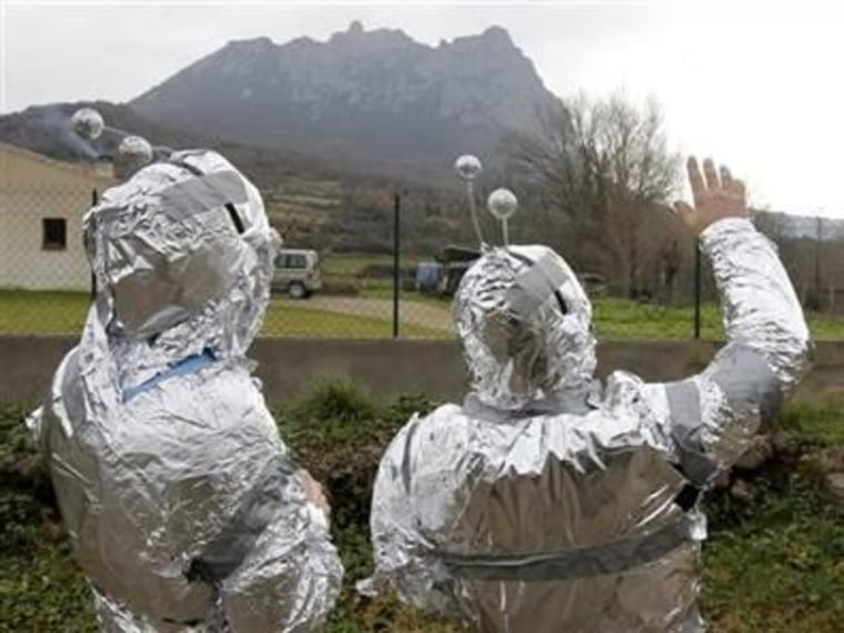 Two men dressed in tinfoil stand in the French village of Bugarach. The mountain near Bugarach was touted as a haven from the Maya apocalypse last December. The mountain survived, as did everything else.