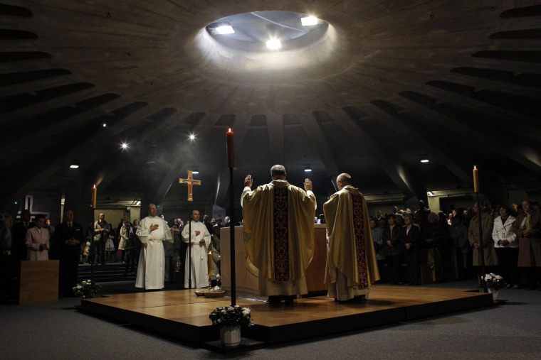 Priests conduct Holy Mass at the Temple of Divine Providence in Warsaw Sept. 30, 2012.