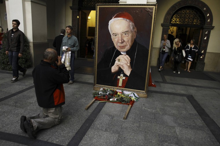 A Catholic prays in front of the picture of former Polish Cardinal Stefan Wyszynski a day prior to celebrations of the Assumption of Mary at Jasna Gora Monastery in Czestochowa, Poland, Aug. 14, 2012.