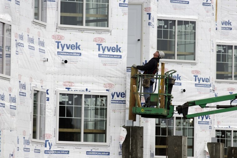 In this Friday, Jan. 11, 2013 photo, a construction worker works at a new home under construction in Chicago.