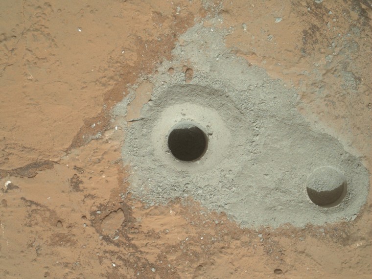 At the center of this image from NASA's Curiosity rover is the hole in a rock called