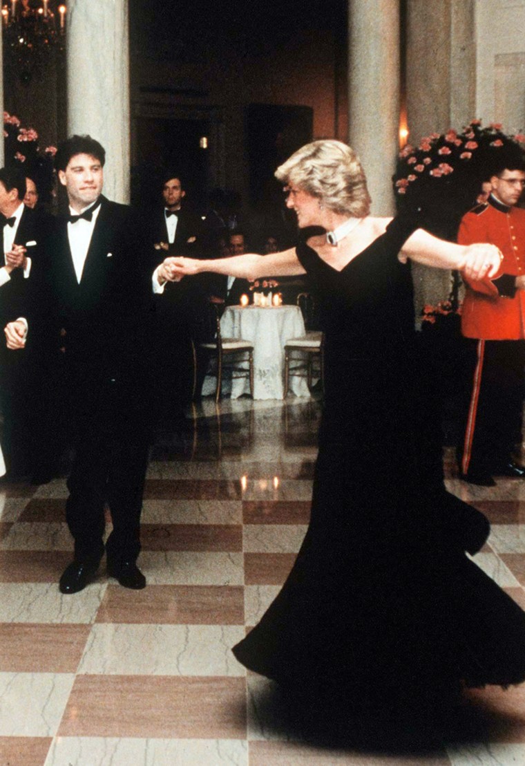 Princess Diana dancing with John Travolta at the White House in one of the gowns for sale: a midnight-blue velvet dress designed by Victor Edelstein.