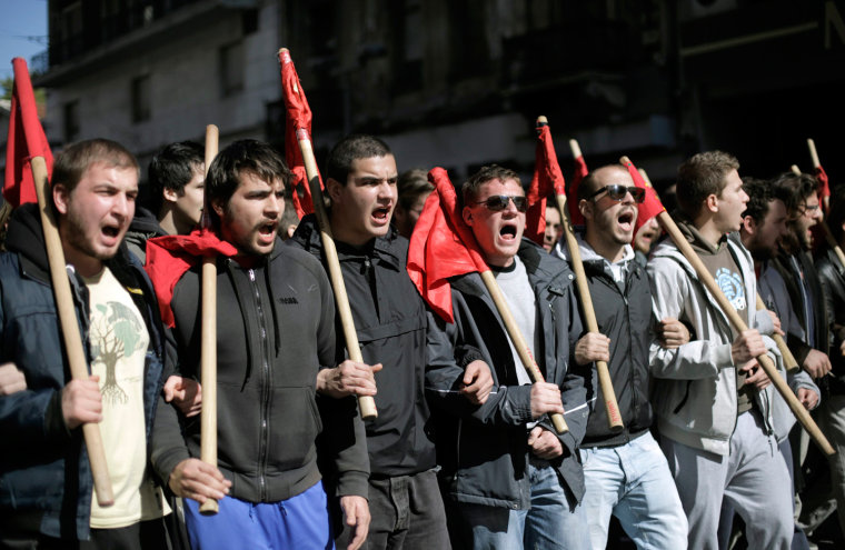 Protesters march during a 24-hour strike in Athens, Feb. 20, 2013. Tens of thousands of Greeks took to the streets of Athens on Wednesday during a nationwide strike against wage cuts and high taxes that kept ferries stuck in ports, schools shut and hospitals with only emergency staff.