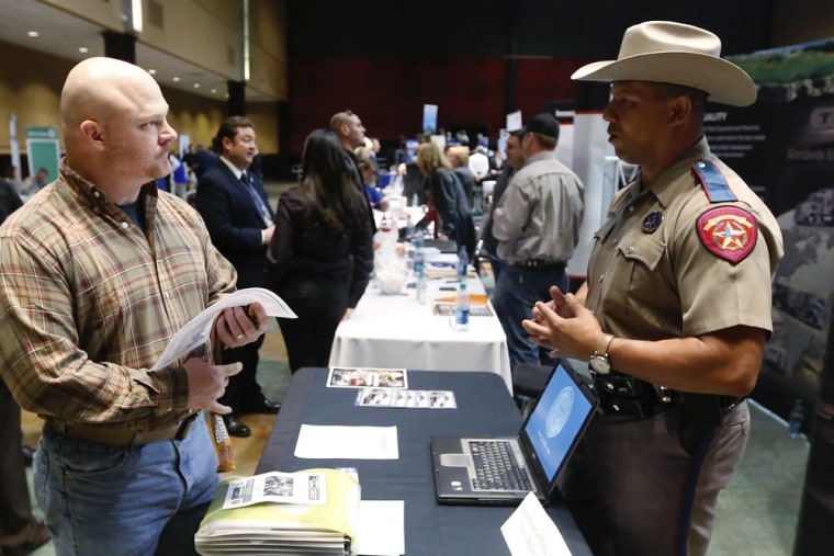 Job Seeker Brett Culver, left, of Newalla, Okla., formerly of the Air Force, talks with Texas state trooper Deon Cockrell, right, at a Recruit Militar...