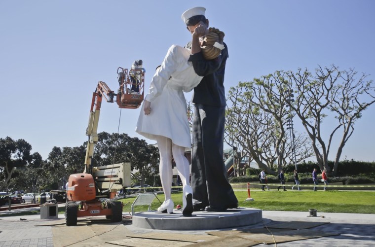 Finishing touches are made to the new kissing sailor statue on the embarcadero adjacent the USS Midway museum in San Diego. The statue, which was modeled after the renowned photograph by Alfred Eisenstaedt taken at the end of World War II, replaces a similar version that was moved out of San Diego last year.