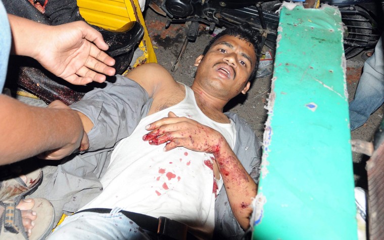An injured man is carried to hospital from the site of a bomb blast in Hyderabad.