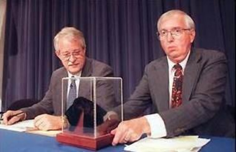 NASA planetary scientist David McKay, at right, unveils the Martian meteorite ALH84001 as NASA Associate Administrator Wesley Huntress looks on during an August 1996 news conference.