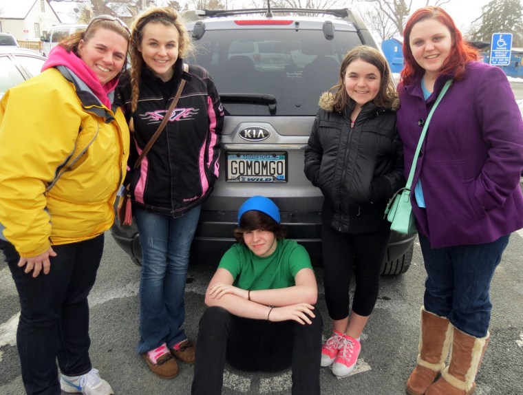 The Hutchinson family stands by mom Jennifer's signature license plate.