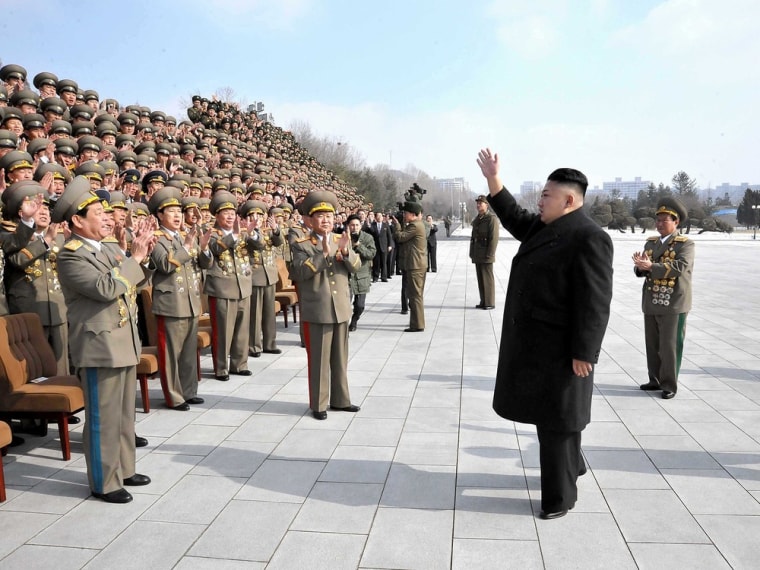 North Korean leader Kim Jong-Un (second right) waves to a crowd of military officials in this undated photo released by North Korea's official Korean Central News Agency Saturday.