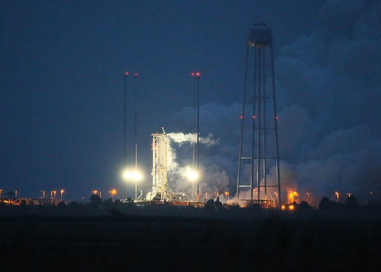 Orbital Sciences Corp. lights up the engines on its Antares rocket for a hot-fire test at the Mid-Atlantic Regional Spaceport in Virginia on Friday.