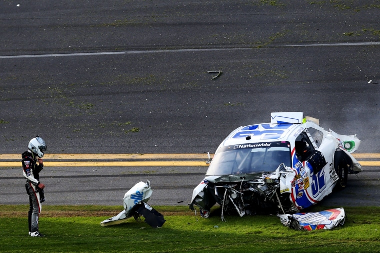 Kyle Larson, driver of the #32 Clorox Chevrolet, looks at his car following the crash.
