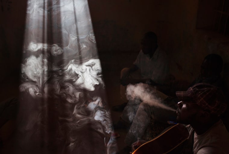 Men smoke in a room in Gao, Mali, Feb. 24.