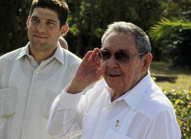 Cuba's President Raul Castro (R) gestures while talking to the media at the Soviet Soldier monument in Havana February 22, 2013.