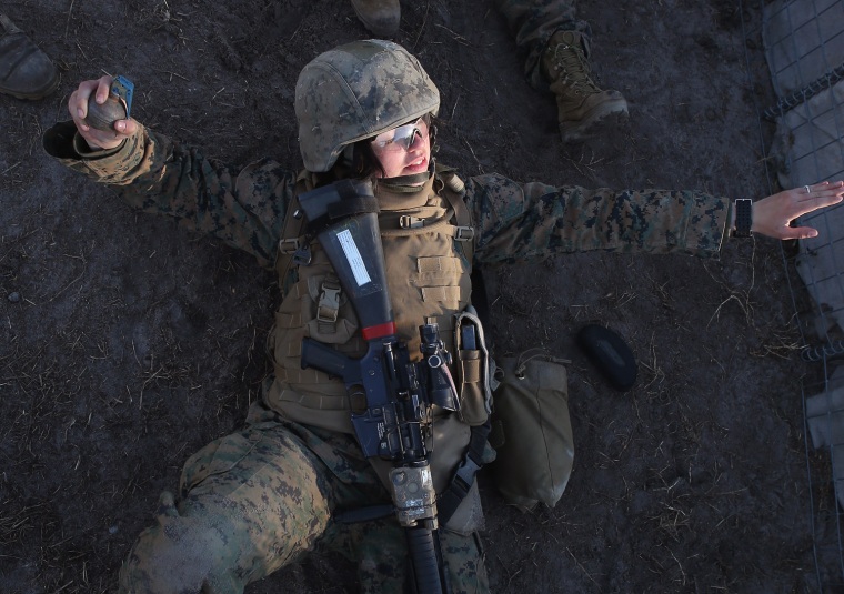 Pvt. Kristain Oldham from Peoria, Illinois prepares to throw a practice grenade during Marine Combat Training.