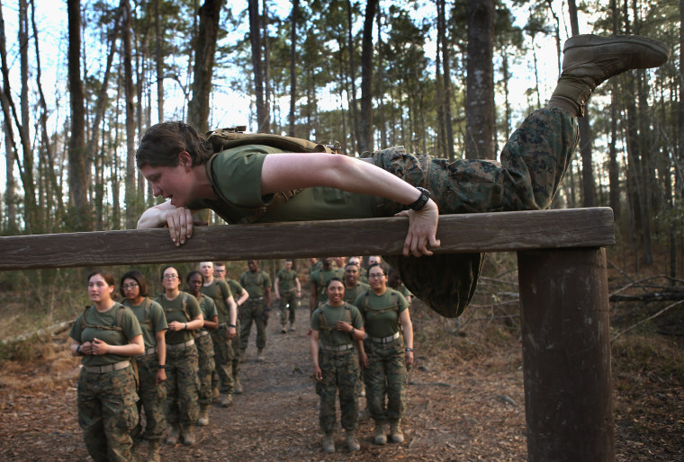 Pfc. Tiernie Gayle climbs over an obstacle on the Endurance Course.