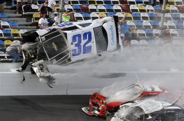 Kyle Larson (32) goes airborne and into the catch fence during a multi-car crash involving Justin Allgaier (31), Brian Scott (2) and others during the...