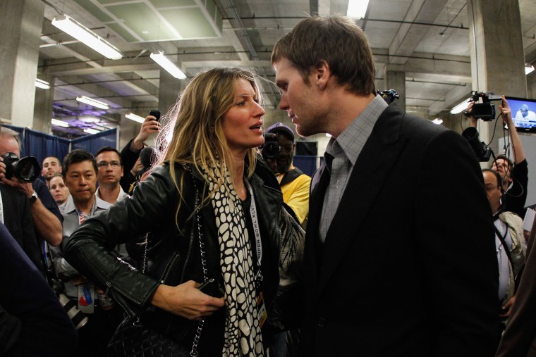 Giving a pep talk? Gisele holds her husband Tom Brady's attention.
