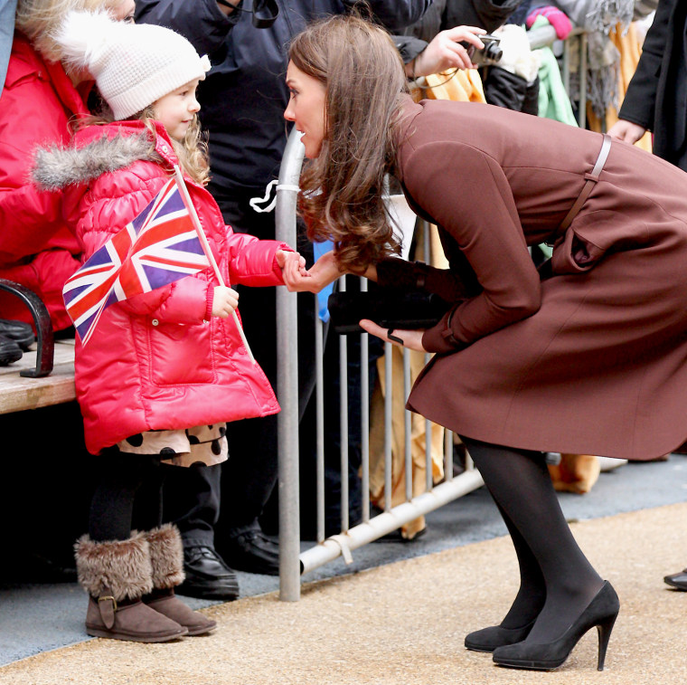The Duchess of Cambridge, clad is her signature black pumps, meets a young girl as she visits Alder Hey Children's NHS Foundation Trust on Feb. 14 in Liverpool, England.