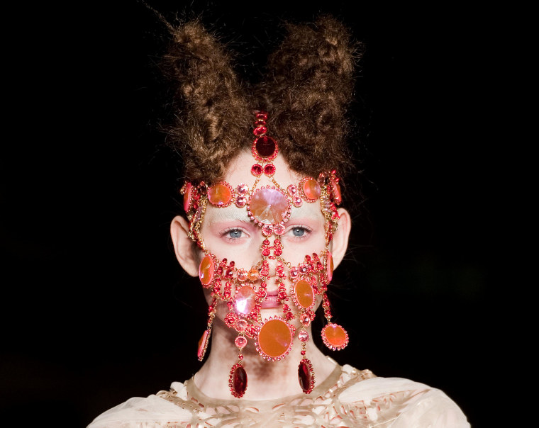 A model wears a jewelled head-piece by Lara Jensen as she walks on the catwalk during the Inbar Spector presentation at London Fashion Week in London on Feb. 20.