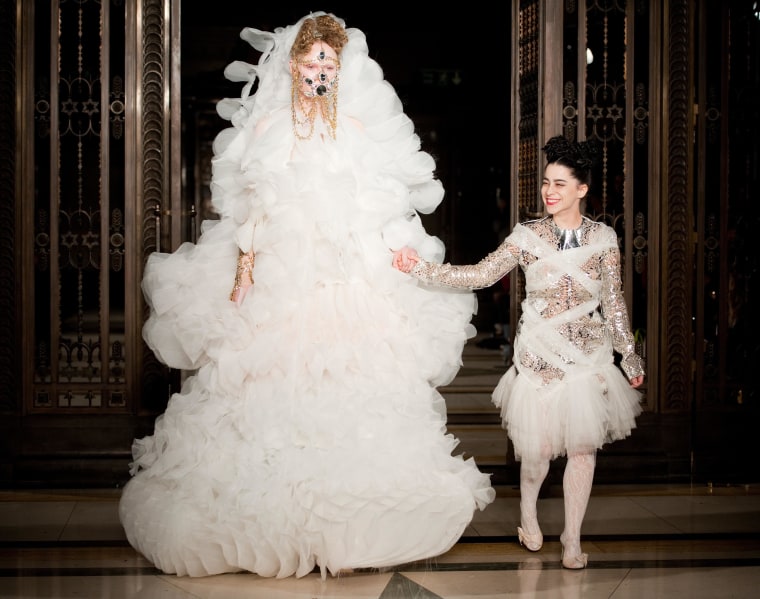 Israeli-born designer Inbar Spector walks with a model on the runway following her presentation.