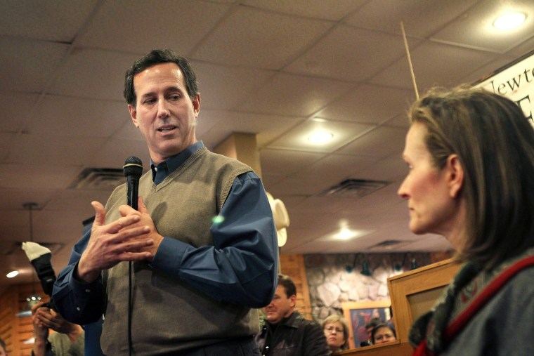 Republican presidential candidate former U.S. Senator Rick Santorum (R-PA) speaks to supporters with his wife Karen by his side at a campaign rally at the Pizza Ranch restaurant on Jan. 2 in Newton, Iowa
