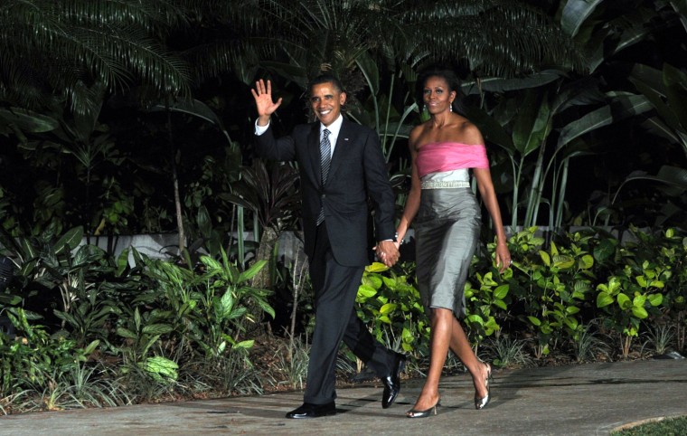 Mrs. O, in a not-quite-strapless dress, and the President arrive for a welcoming ceremony in Honolulu on Saturday.