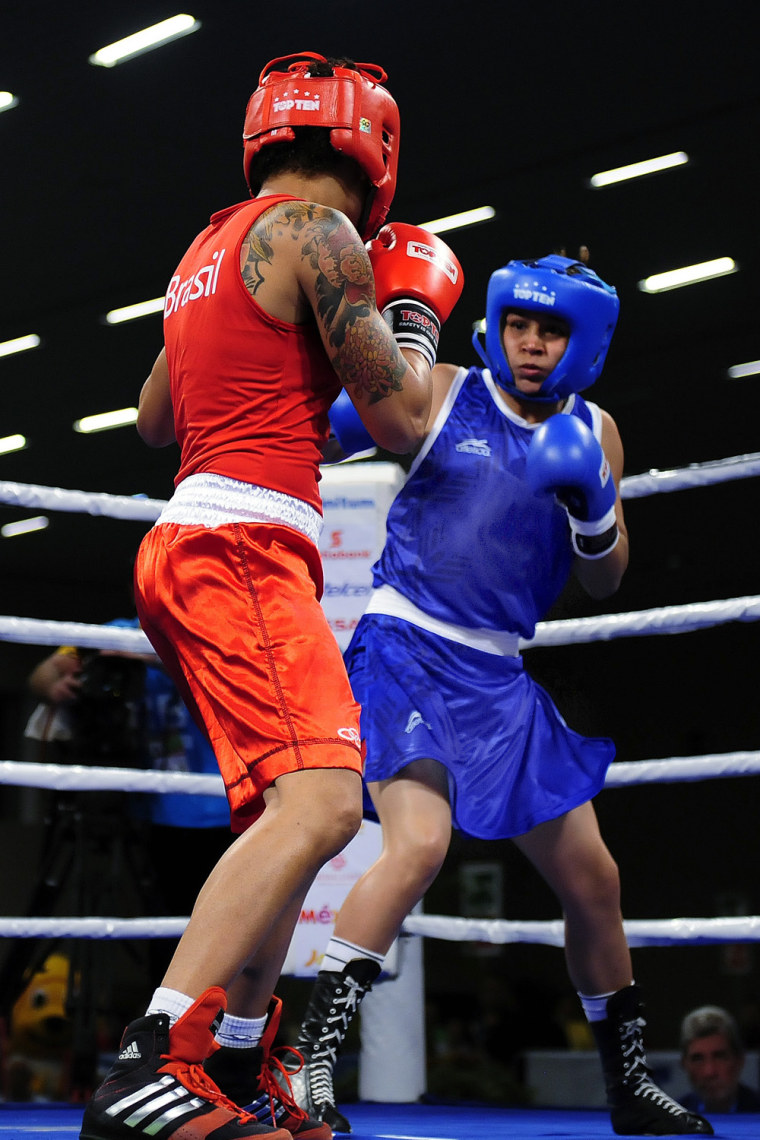 Would it be a better game with skirts? Erika Cruz (in blue) of Mexico fights against Adriana Araujo (in red) of Brazil during the Woman's Light Welter 57-60 kg in the 2011 XVI Pan American Games on October 22, 2011 in Guadalajara, Mexico.