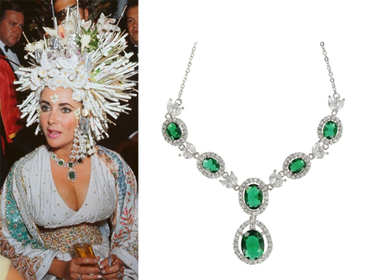 Elizabeth Taylor wears an elaborate headdress of pearls and fake flowers, a jeweled dress and an emerald necklace. A replica of the necklace is now for sale on Overstock.com for $99.99.