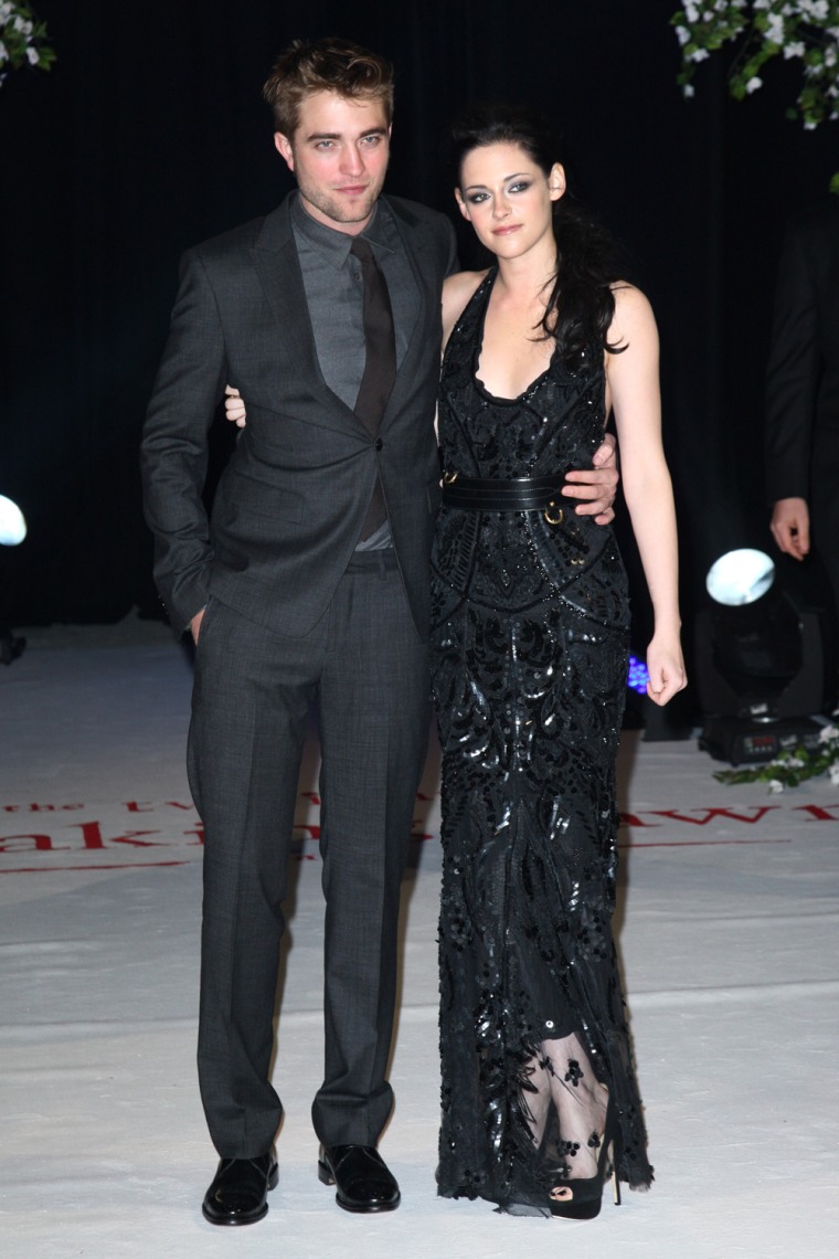 Well, that look didn't last long. Kristen Stewart, in heels, poses with Robert Pattinson at the UK premiere of